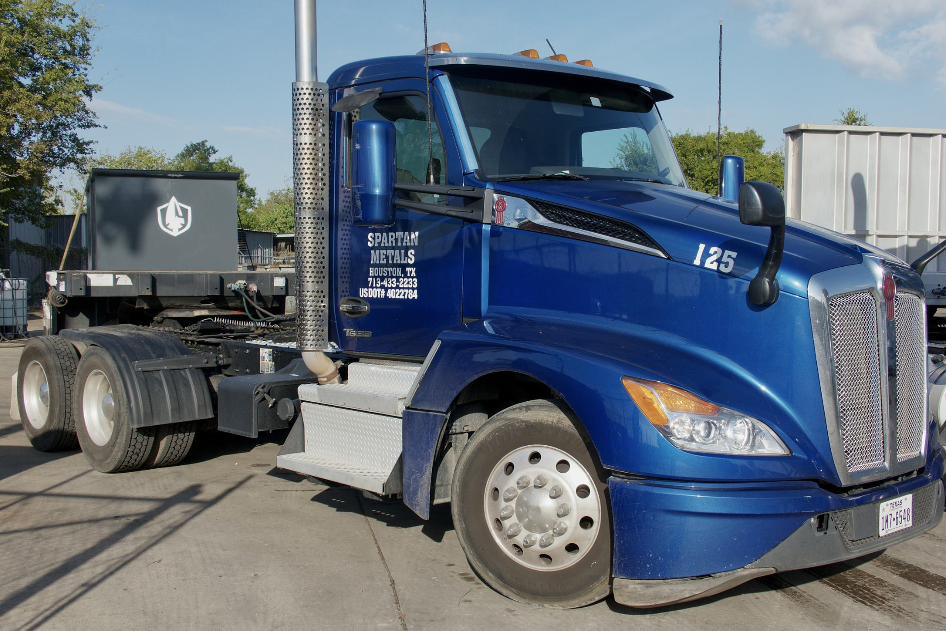 Spartan Metals truck 125 in the Houston yard with a Spartan steel bin on the trailer