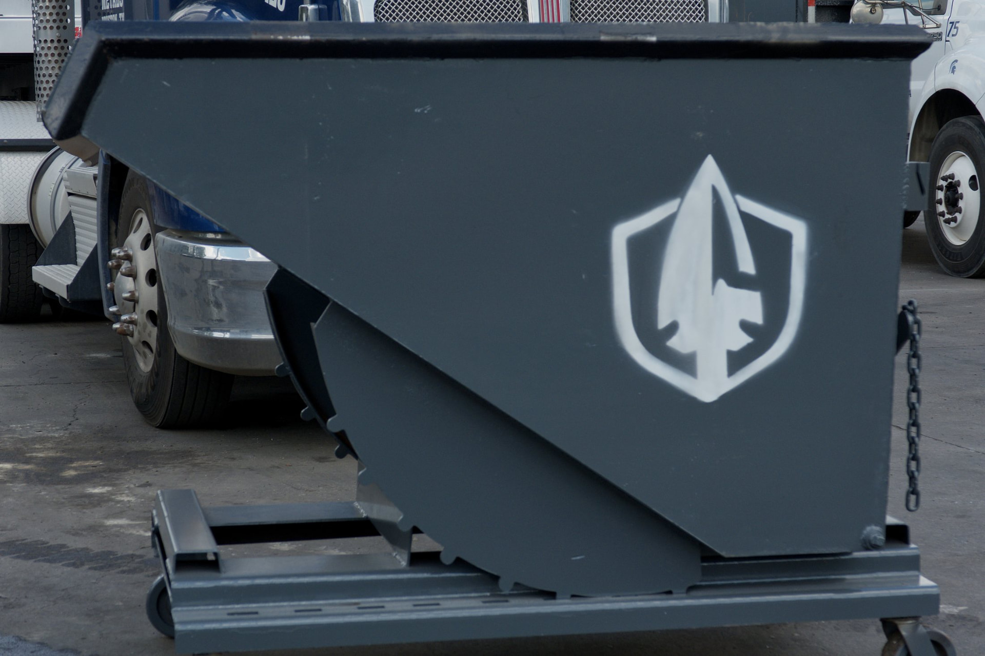 Self-dumping hopper with the white Spartan shield logo
